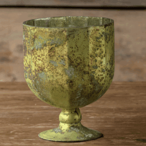 Antique greenish metal goblet with a rustic finish.